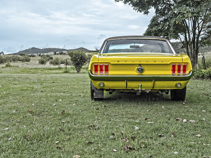 photography of classic yellow Ford Mustang