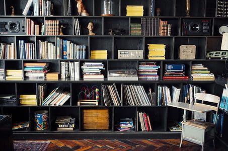 book lot on black wooden bookshelf