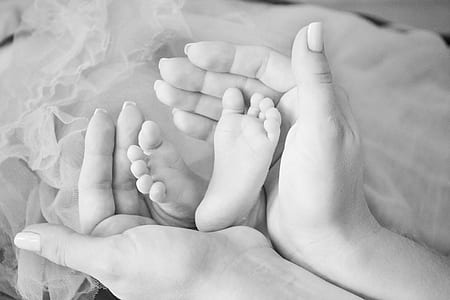 person holding baby's feet