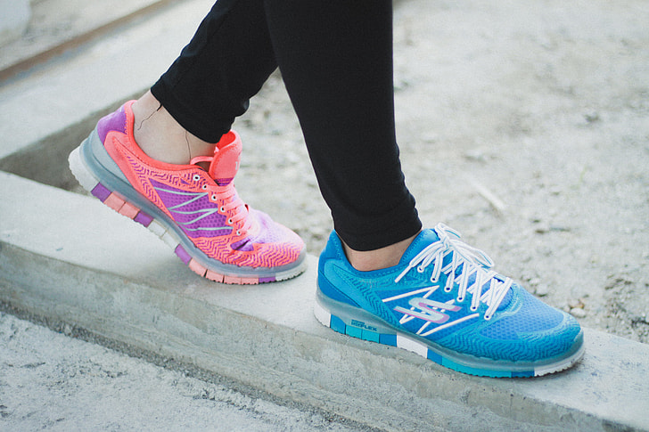 person wearing blue and pink athletic shoes