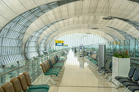 person taking photo of plane terminal interior