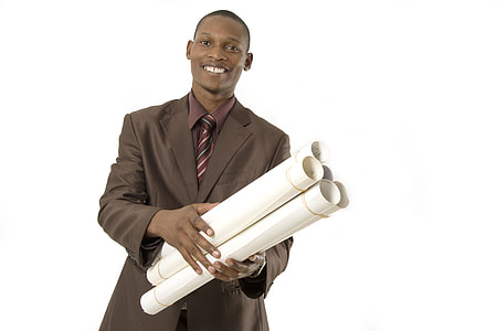 smiling man holds white paper lot