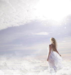 photo of woman in white spaghetti strap dress on clouds