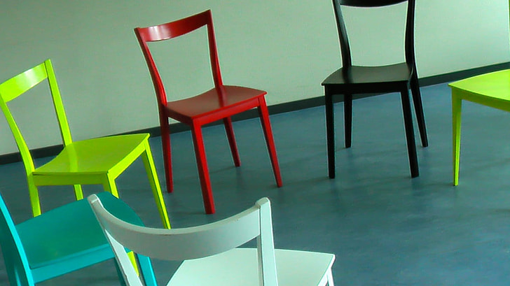 six assorted-color chairs on blue floor