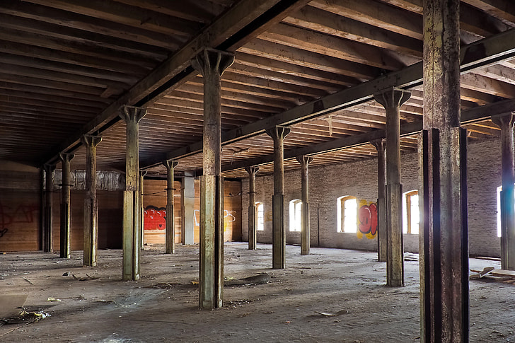 empty warehouse with rusted metal posts