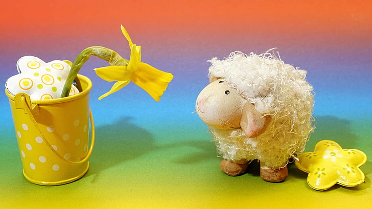sheep plush toy looking at yellow artificial flower on steel pot