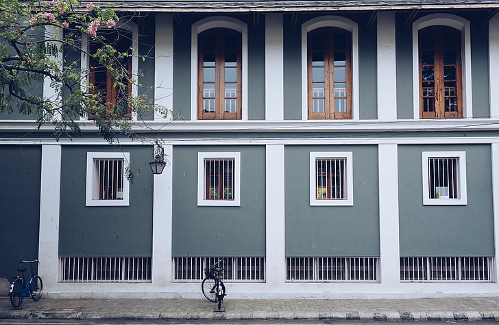 two bicycle in front of a two-storey house