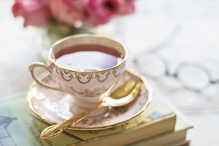 white and gold-colored teacup set