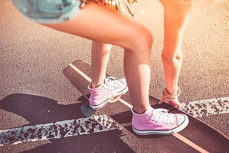 Young Girl with Pink Shoes on Longboard