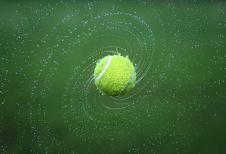 wet tennis ball floats in air