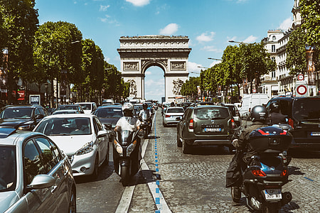 Wide angle shot of the busy road traffic on the famous Champs Elysees in Paris, France. At the end of the road you can see the Arc de Triomphe. This image was captured with a Canon 6D. 