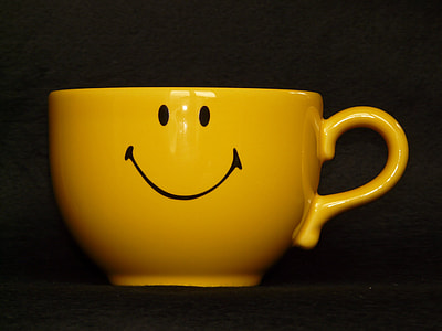 selective focus photography of yellow ceramic cup