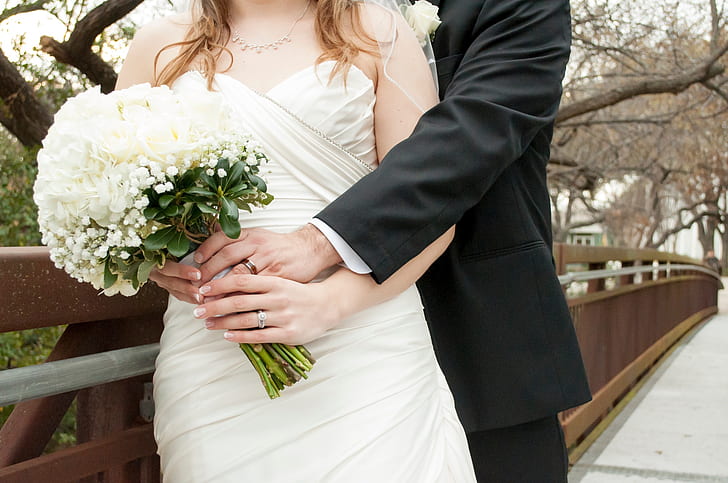 woman holds white bouquet