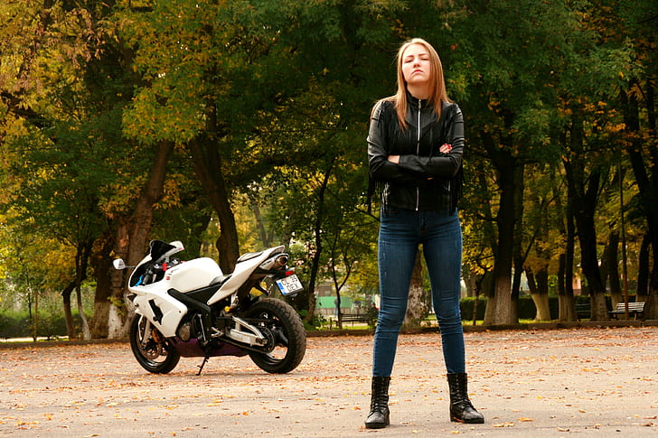 woman wearing black leather zip-up jacket with motorcycle