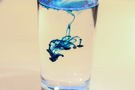 blue ink drop in water in glass