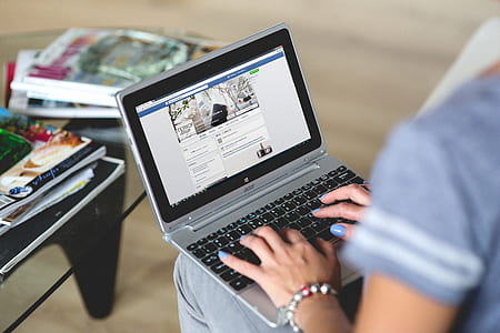 photo of woman holding silver Acer laptop