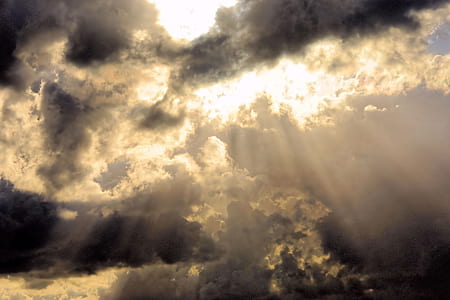 perforated sun rays under cumulonimbus clouds