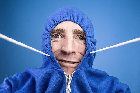man wearing blue zip-up hoodie