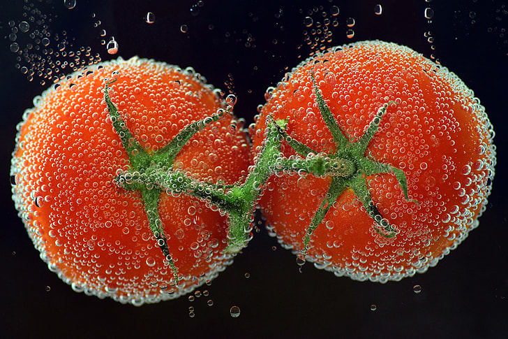 two tomatoes under the water
