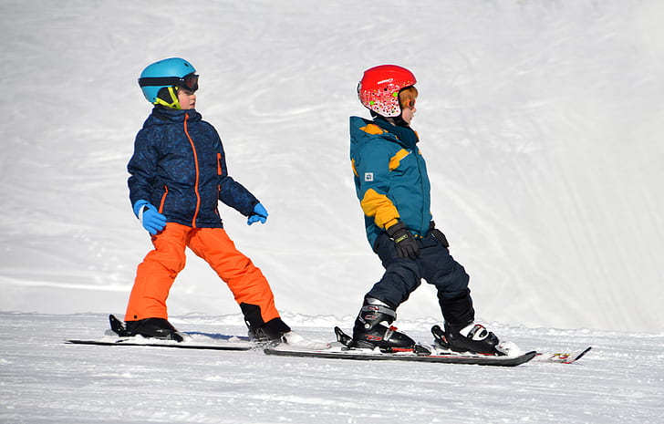 photography of children riding snowboards