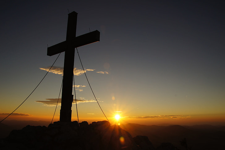 silhouette of cross decor during sunset