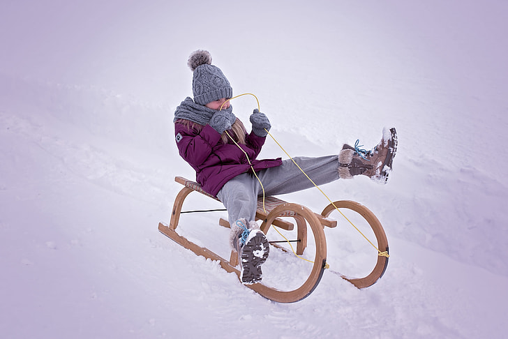 child riding sled