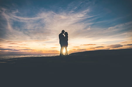 silhouette of hugging man and woman during golden hour