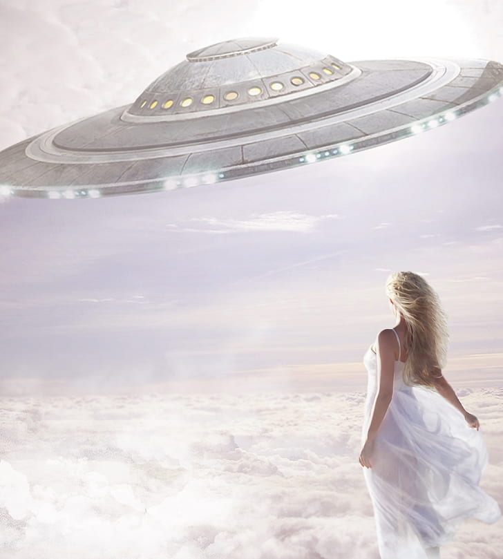 woman wearing dress looking at round spaceship painting