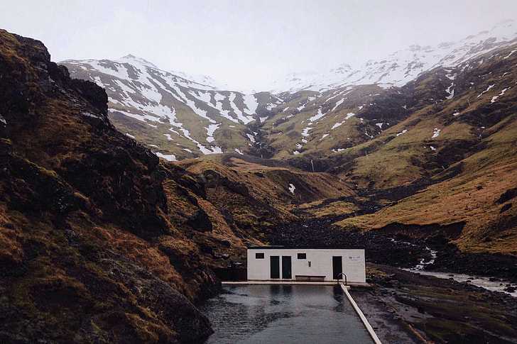 A building sits in the dramatic mountain landscape in Iceland