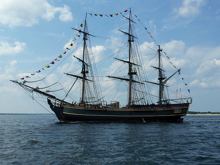 brown and green galleon ship on body of water during daytime