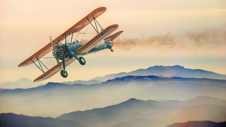 illustration of brown and blue biplane flying over mountain