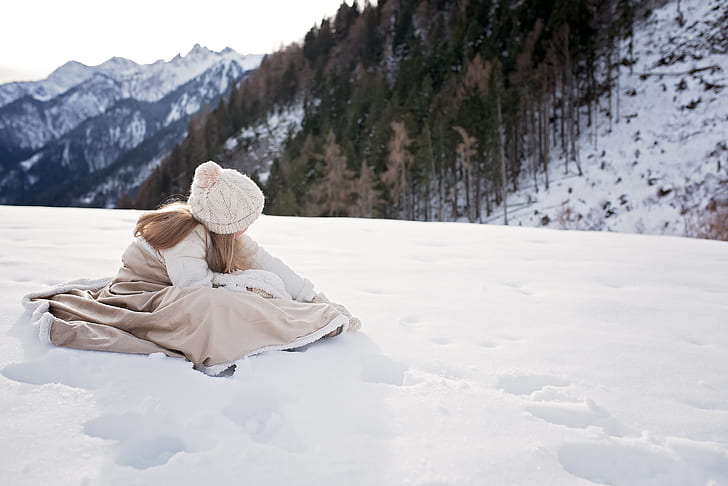 girl in brown dress on snowy mountain during daytime