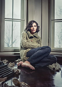 woman sitting beside window