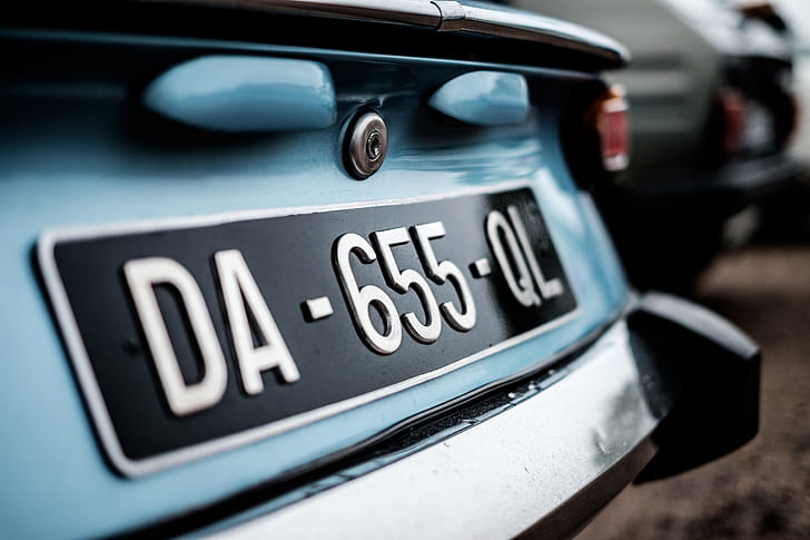 focus photography of car's license plate