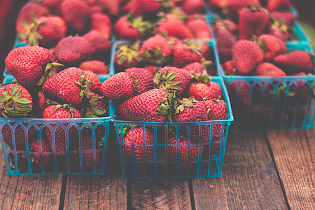 strawberries on blue plastic trays