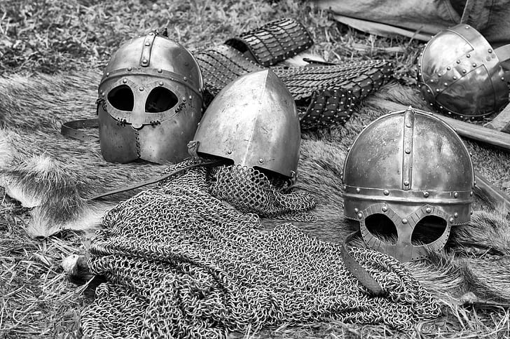 grayscale photo of iron helmets