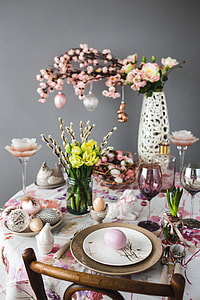 Easter table with cute pink decorations, flowers, catkins and eggs