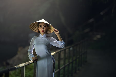 woman wearing sakkat hat leaning on the fence