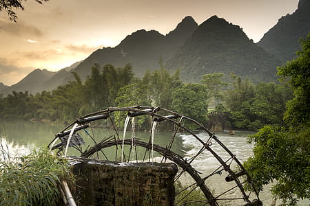 watermill surround by mountains during daytime