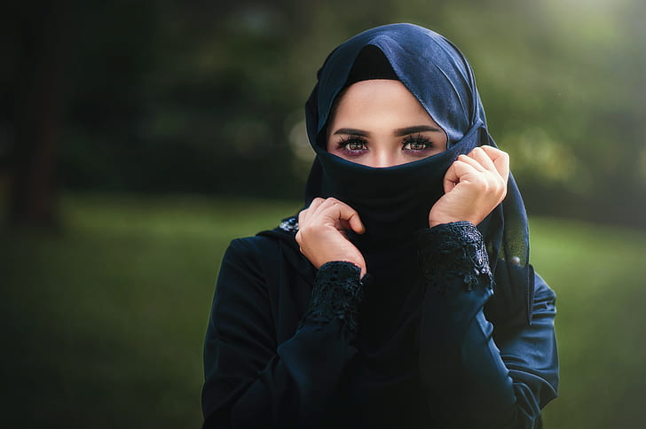 woman wears black abaya dress