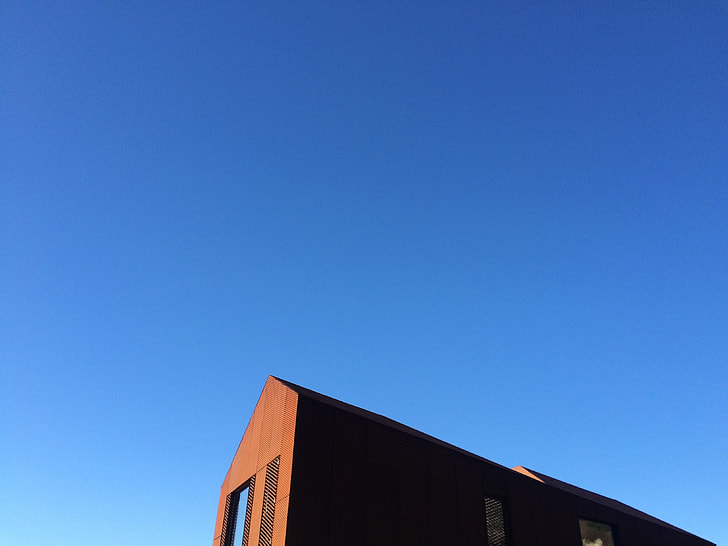 brown wall house under blue sky