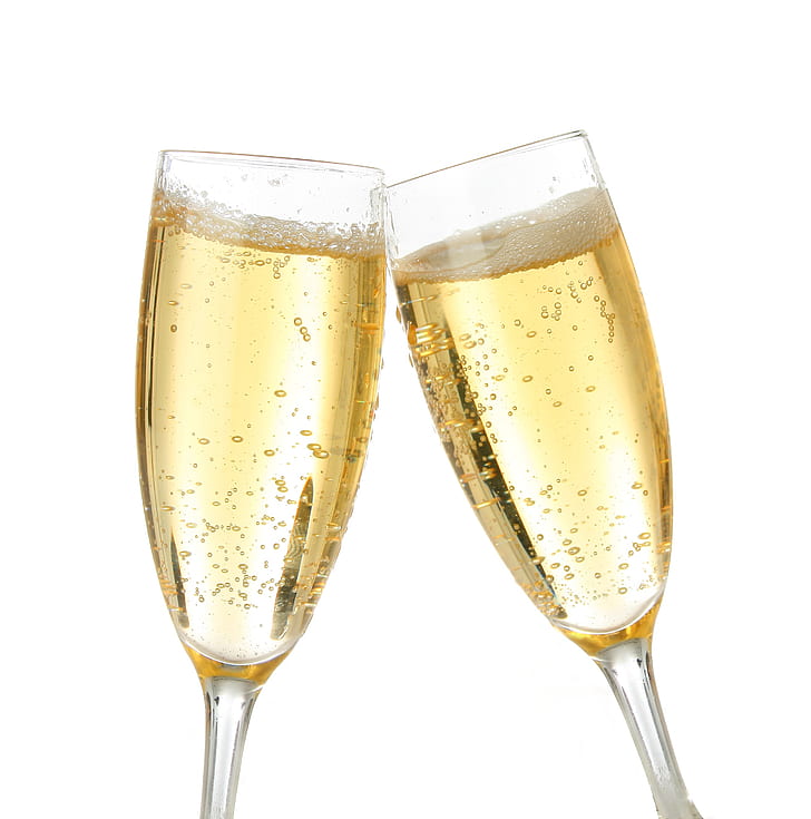 two clear champagne glasses with champagne