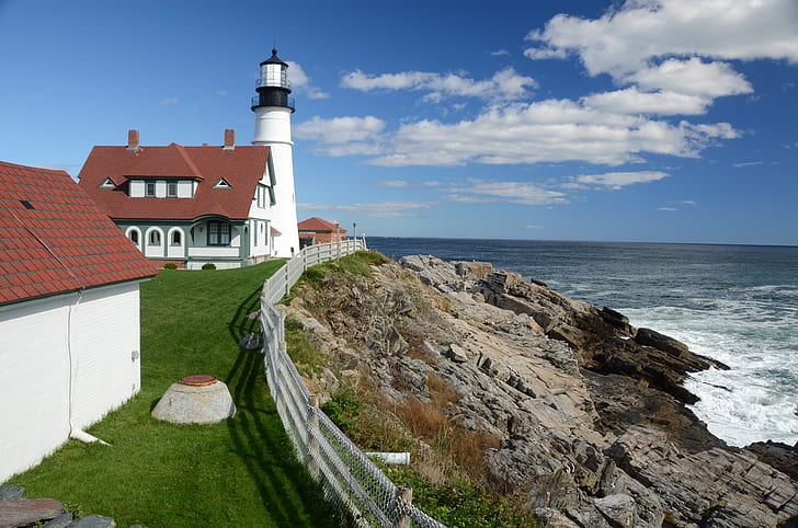 photography of lighthouse near sea during daytime