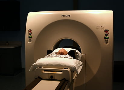 man in white Philips ADAC CT scanner