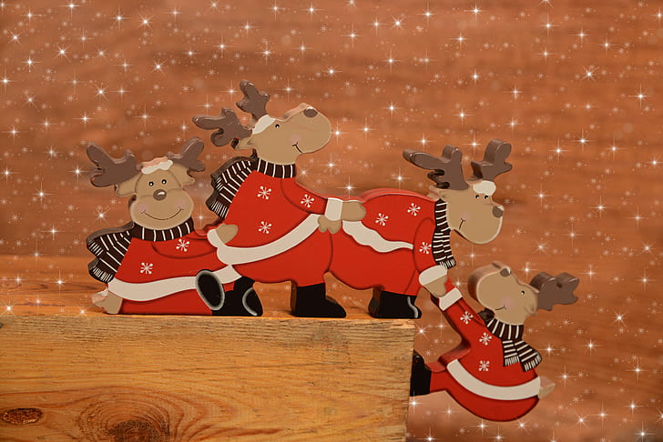 four Christmas deers on brown wooden board decors