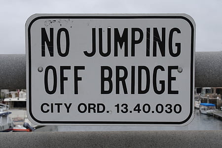 no jumping off bridge signboard