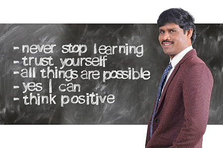 man wearing maroon suit jacket beside inspirational quote