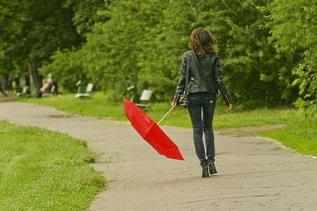 woman holding red umbrella
