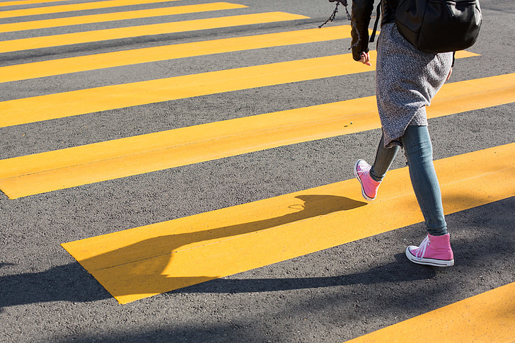 Girl Crossing Street on a Yellow Crosswalk