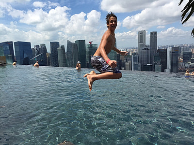 boy jumping on pool